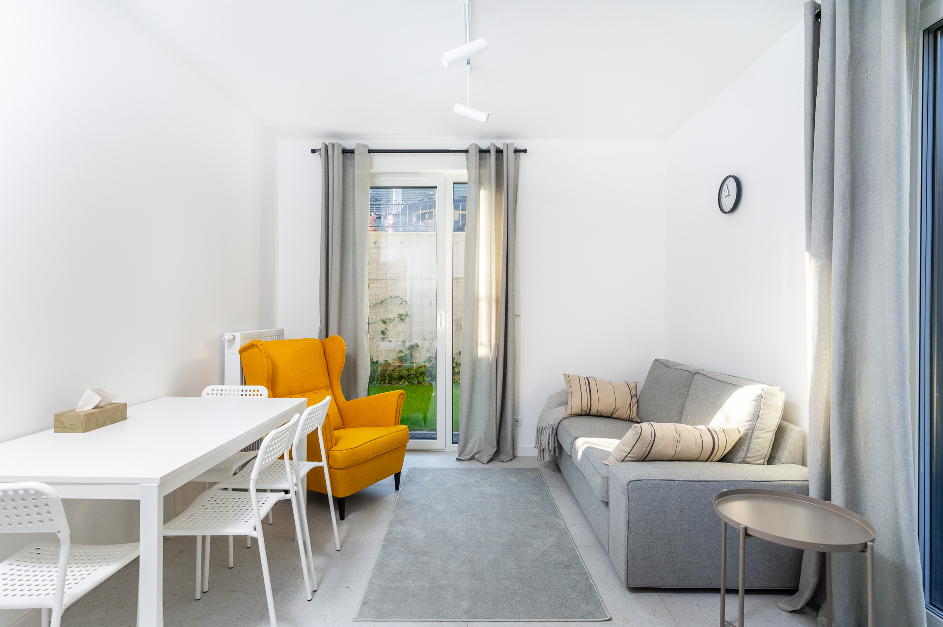 Therapy room with a yellow wingback armchair and a sofa, with access to the garden, Płaszowska 25, Kraków