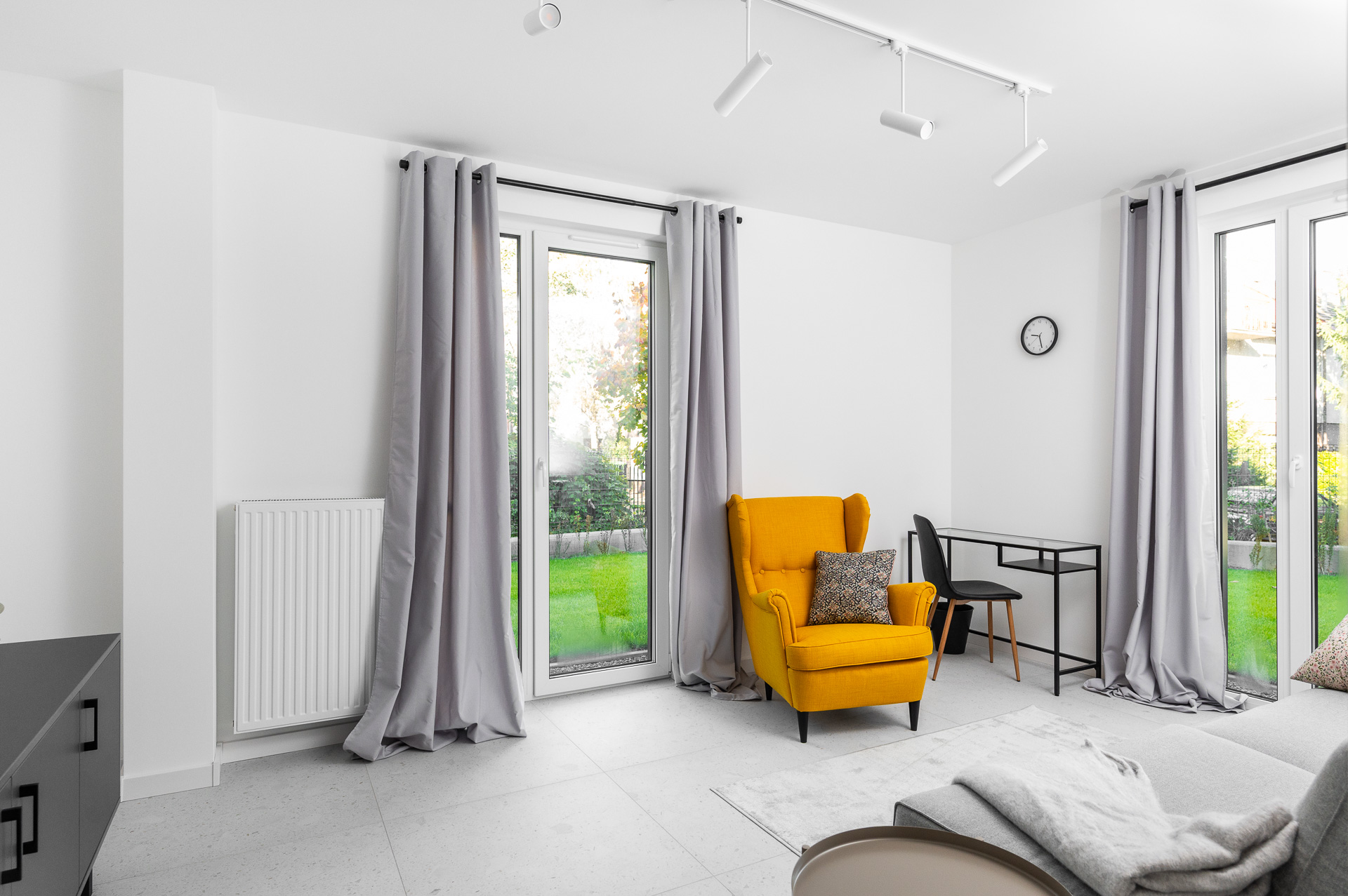 Sunny room with a yellow armchair and a desk, two windows overlooking the garden, Płaszowska 25, Kraków